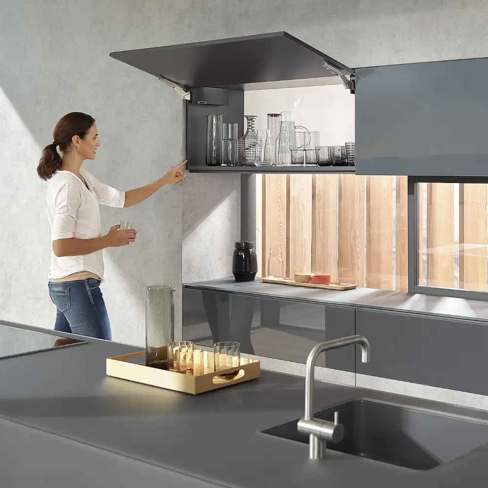 A women operating a Blum AVENTOS lift system